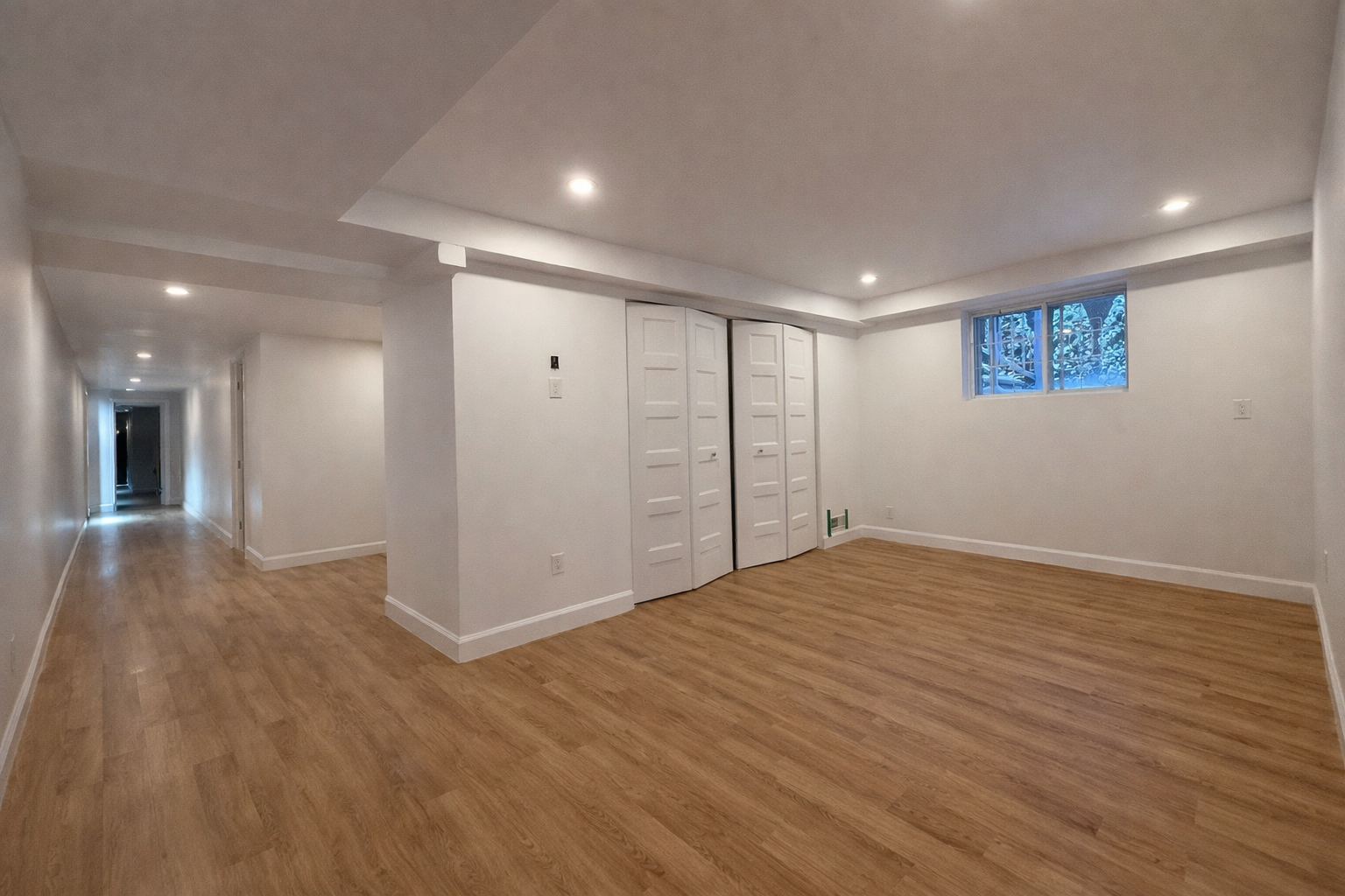 Finished basement bedroom with closet and wood flooring in West Island Montreal