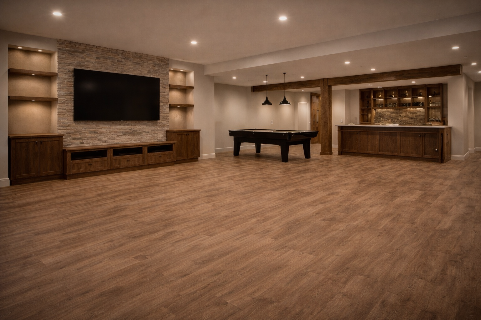 Modern basement renovation in West Island Montreal with custom bar, built-in TV wall and pool table