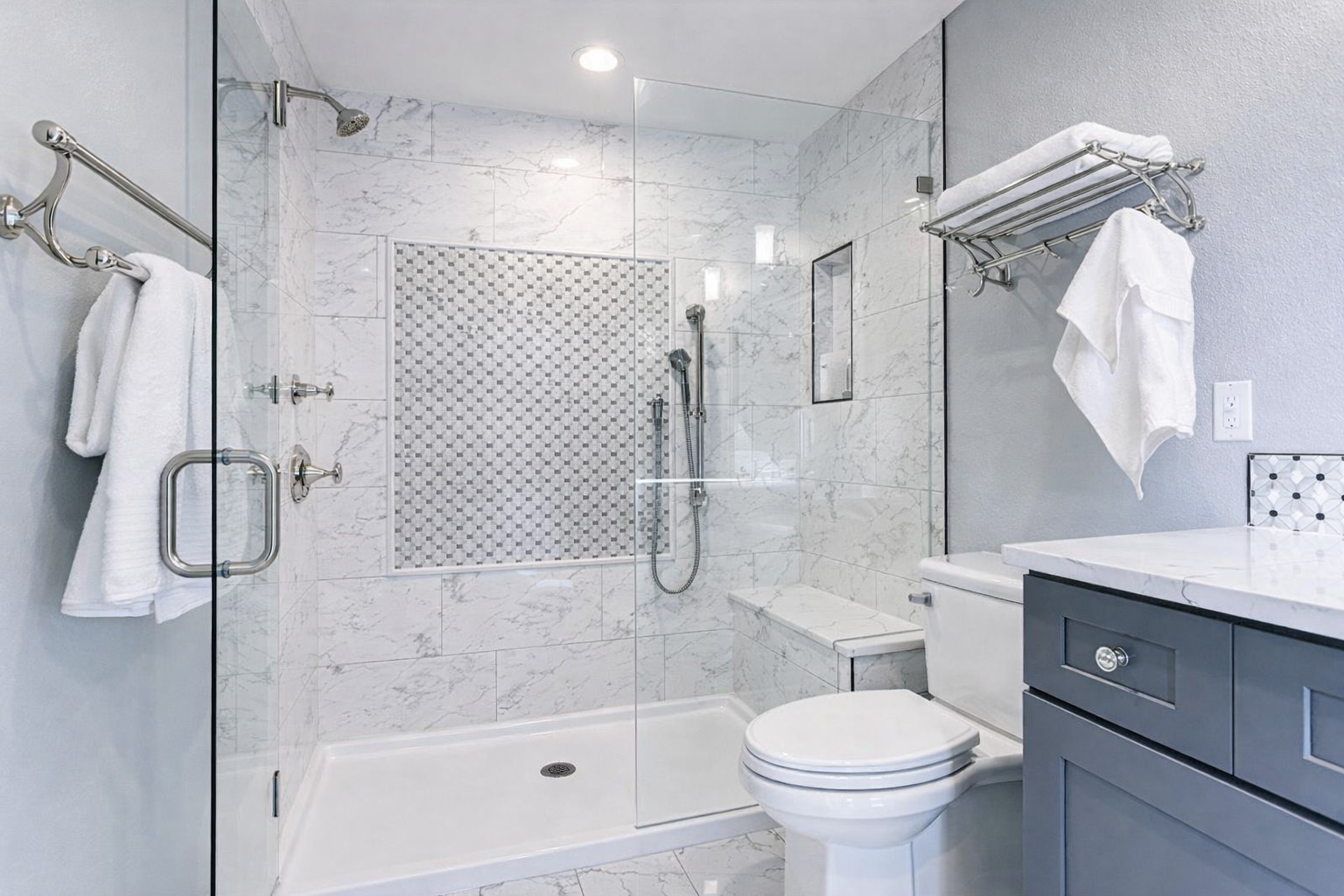 Bathroom with glass shower bench and marble tile in West Island Montreal