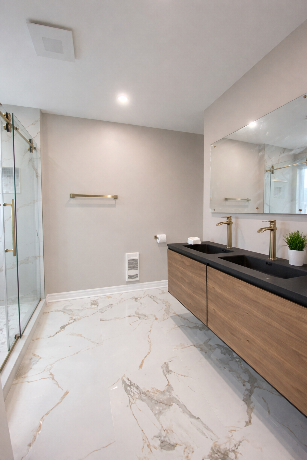 Bathroom with double vanity marble floor and gold fixtures in West Island Montreal