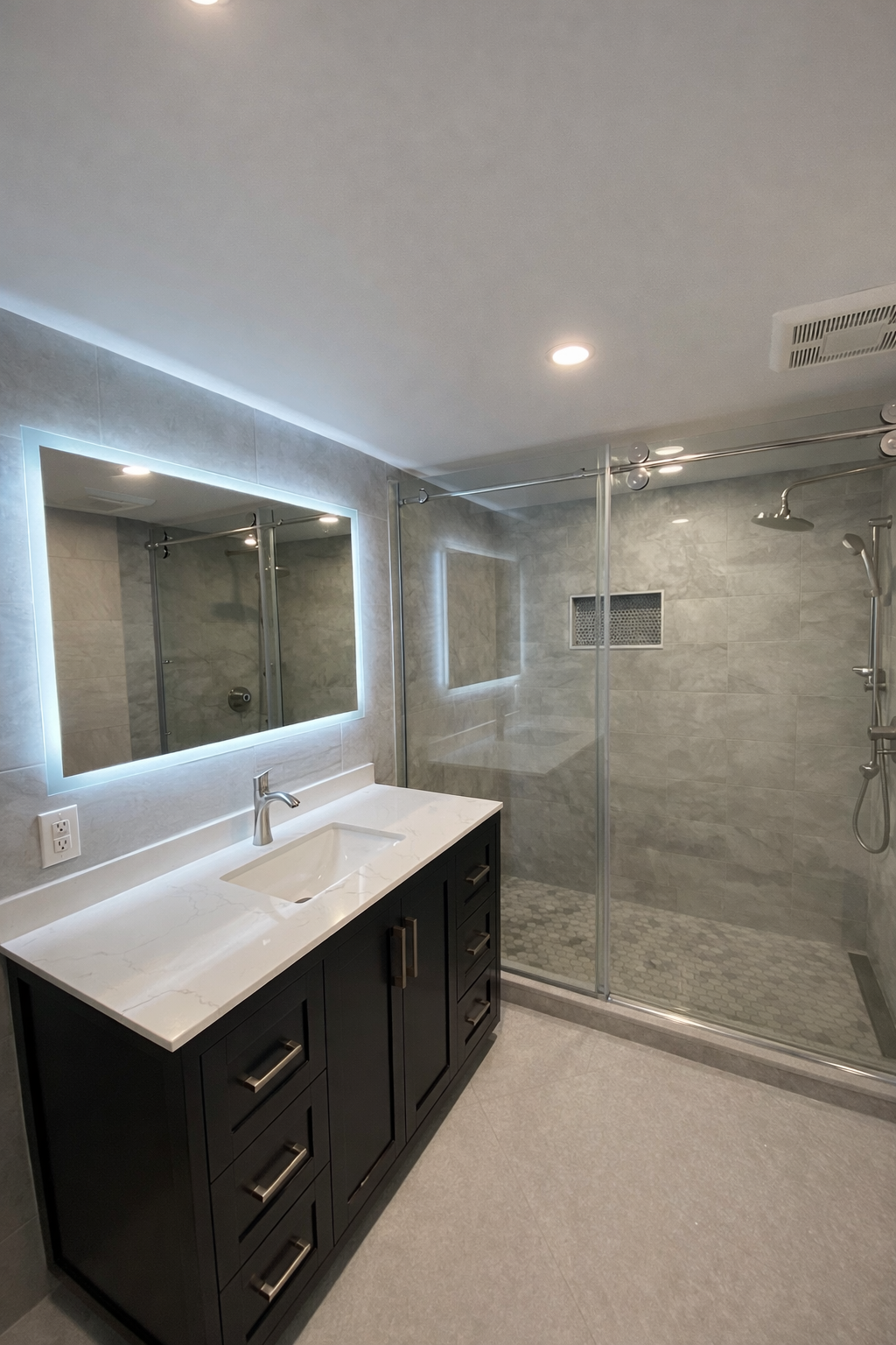 Modern bathroom with glass shower, LED mirror and vanity in West Island Montreal