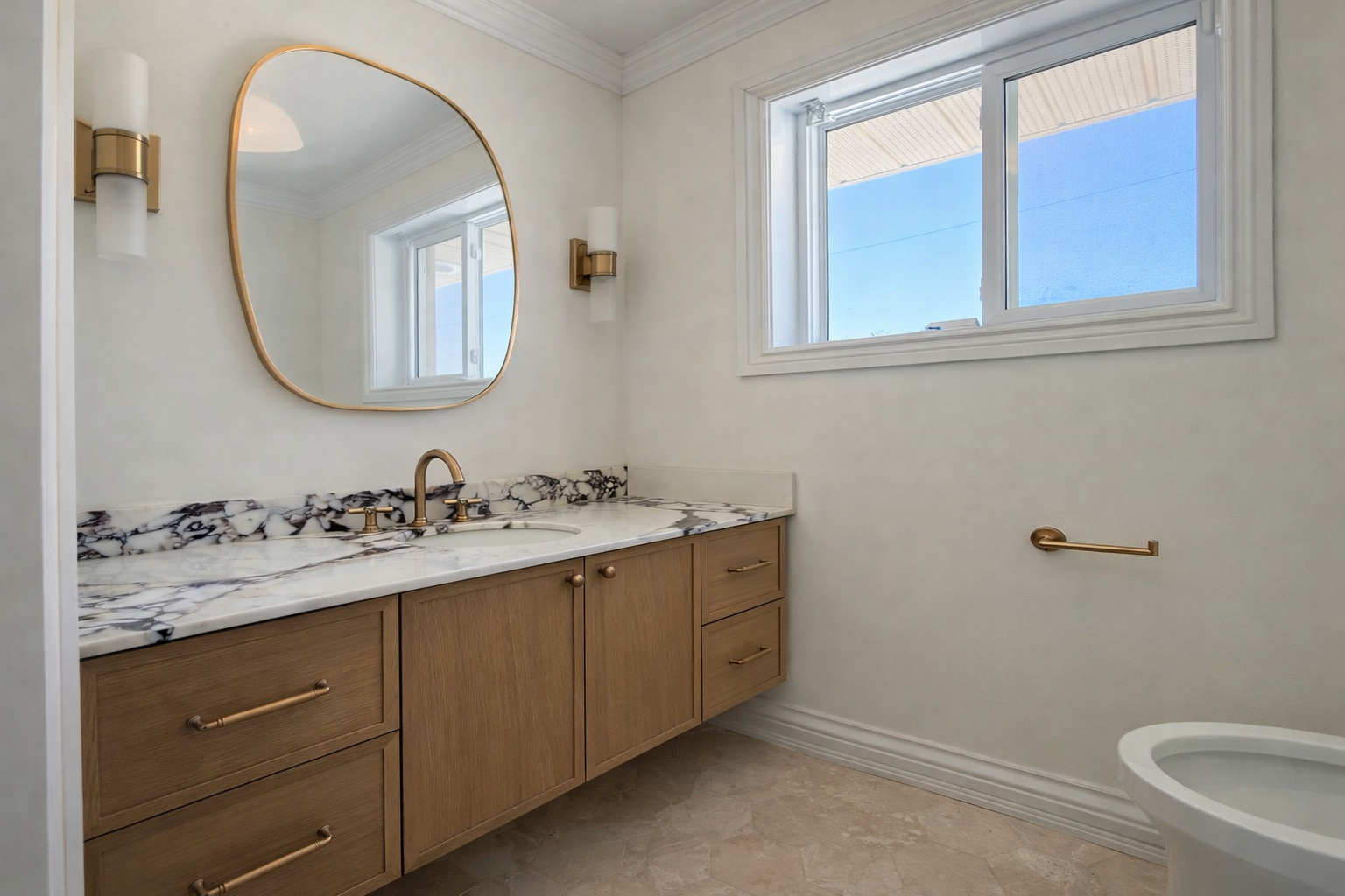 Bathroom renovation with wood vanity and marble countertop in West Island Montreal