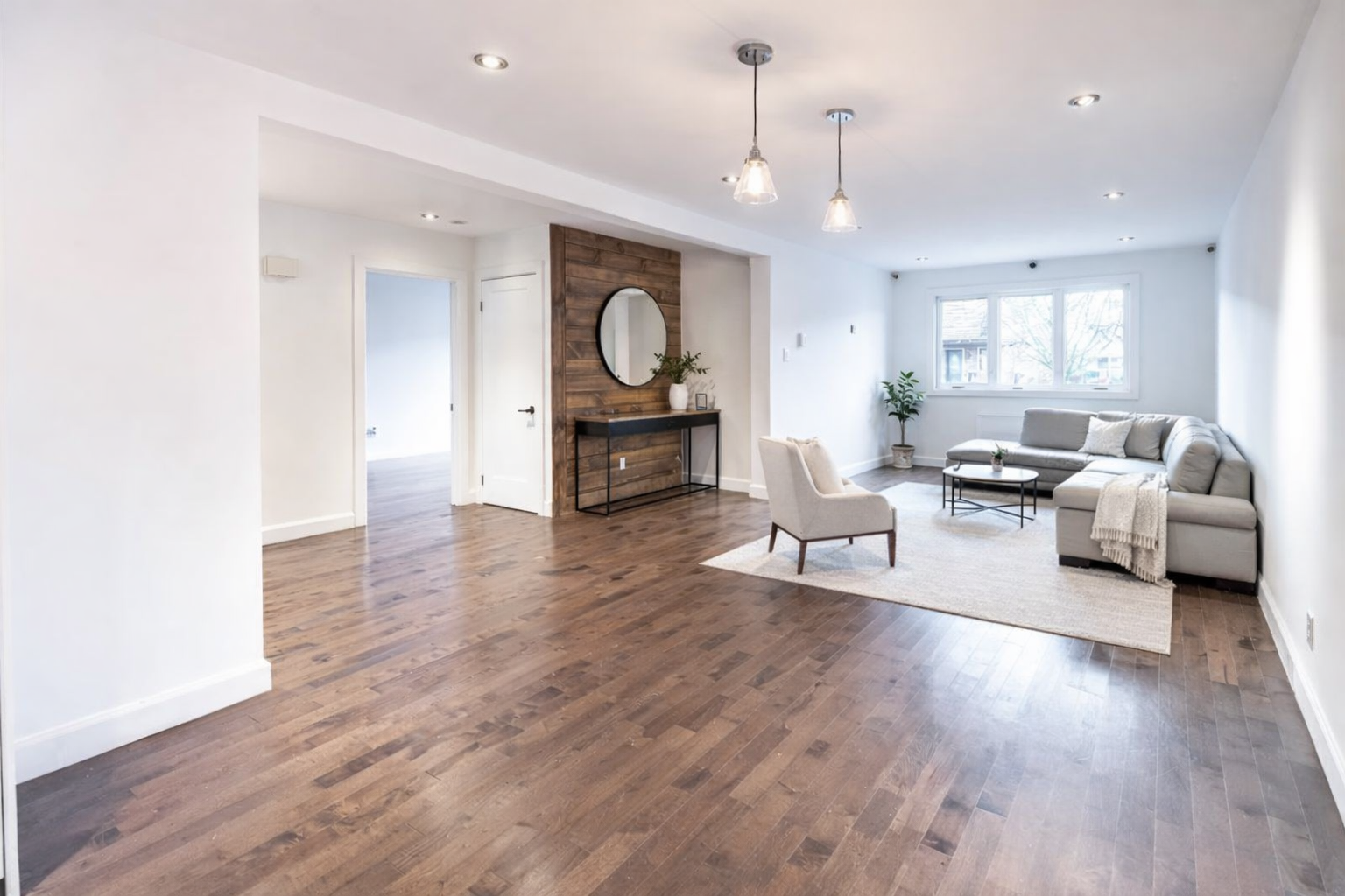 Living room renovation in West Island Montreal featuring hardwood flooring, modern lighting and open-concept layout with clean interior finishes, serving Dorval, Pointe-Claire, Pierrefonds, Kirkland, Beaconsfield, Dollard-Des-Ormeaux and Vaudreuil-Dorion