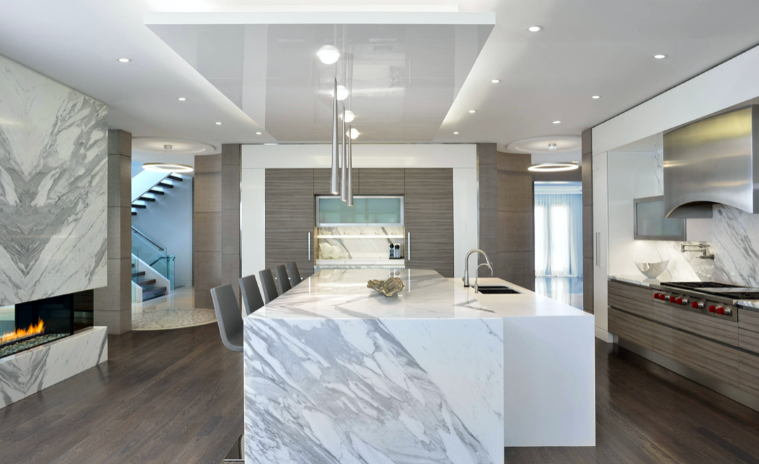 Luxury kitchen renovation in West Island Montreal with marble waterfall island, modern cabinetry and high-end finishes
