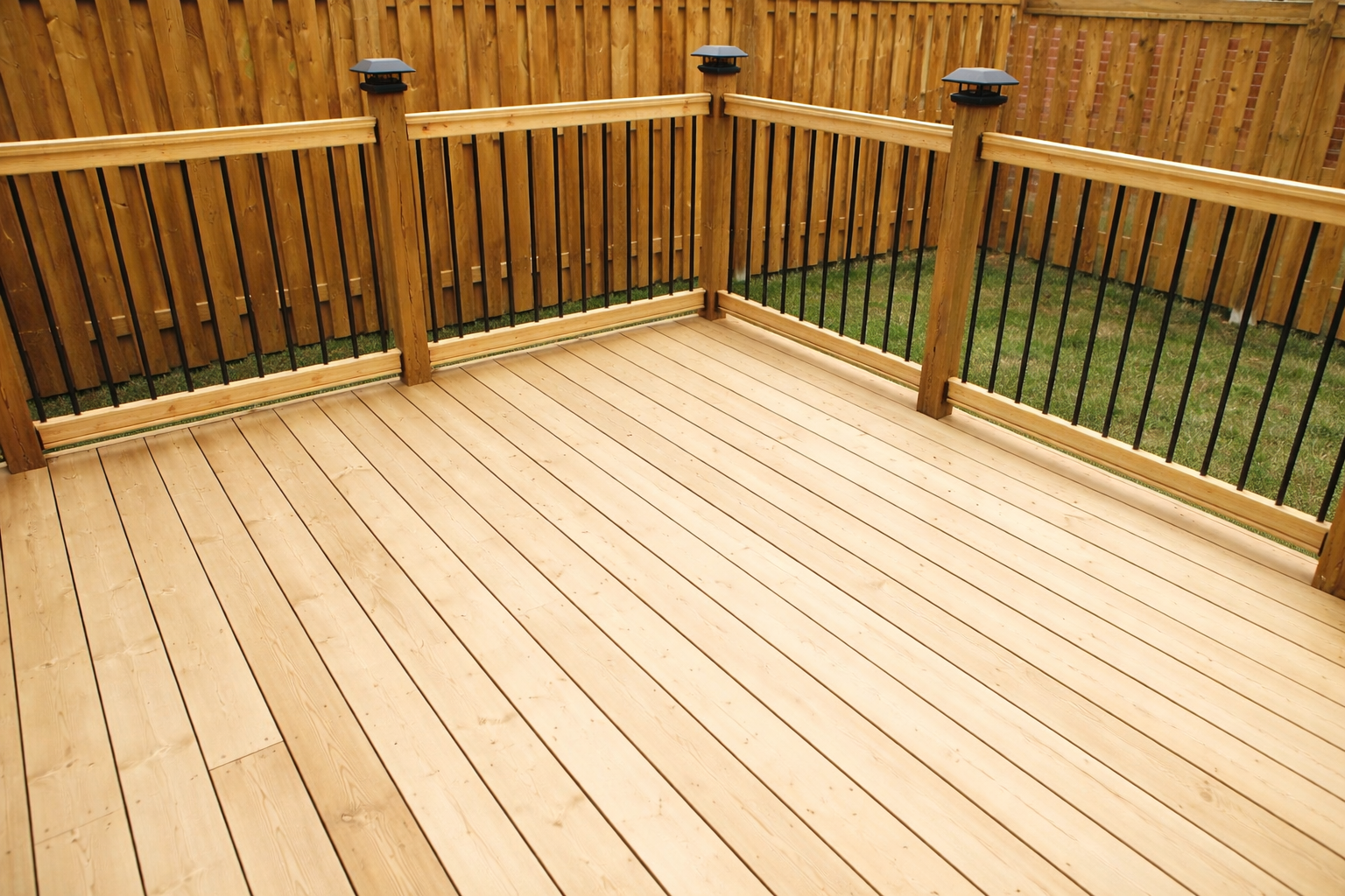 Treated wood deck construction in West Island Montreal with custom railings and pressure treated decking