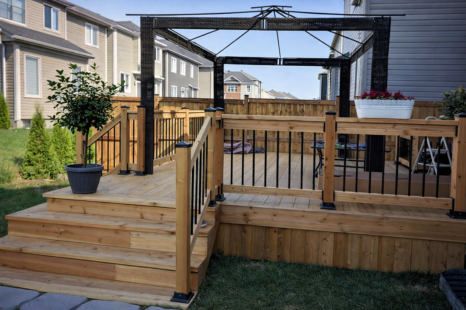 Wood deck construction in West Island Montreal with custom railings, pergola and multi level deck design